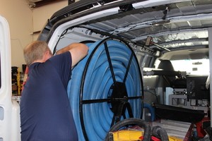 Water Damage Restoration Technician Prepping Suction Hoses